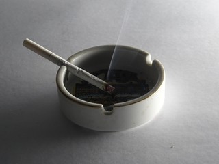 A smoking cigarette in an ashtray