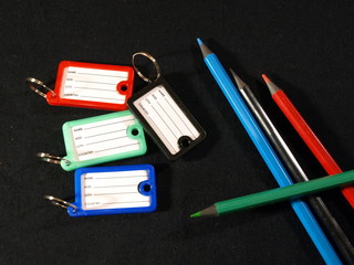 Fototapeta na wymiar Many multi-colored pencils and tags for keys
