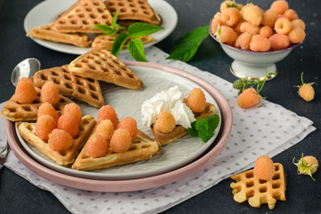 Wafers and yellow raspberries.