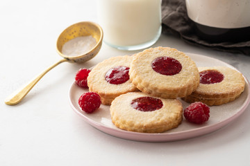 Traditional Christmas Linzer cookies with sweet jam on plate, closeup, copy space.