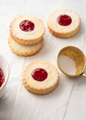 Traditional Christmas Linzer cookies with sweet jam on plate, closeup, copy space.