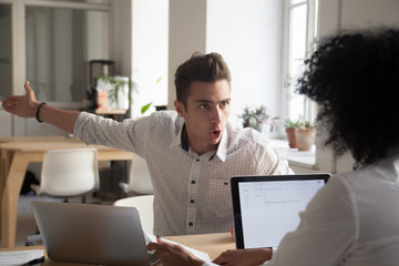 Mad male worker yelling at female colleague asking her to leave office, multiracial coworkers...