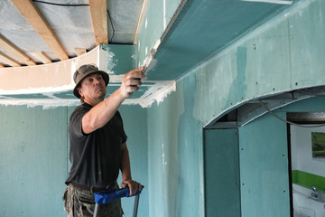 Fototapeta na wymiar worker making repairs in a country house