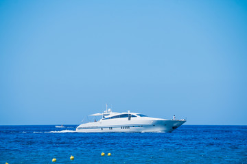 Fototapeta na wymiar Side view of sail boat cruising in blue sea.Sailboat in the sea, active vacation in Mediterranean sea, Sea Luxury Yacht in the Mediterranean sea .Yacht in sunny summer day