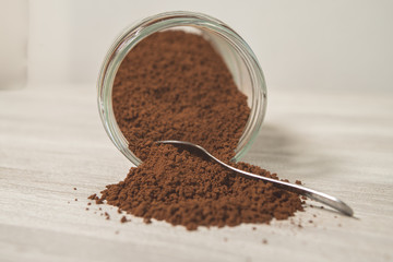 Instant coffee granules scattered brown close up.