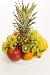 Fruit plate with fresh whole fruits, isolated on white background