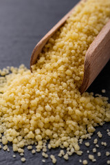 fresh couscous on a dark stone background