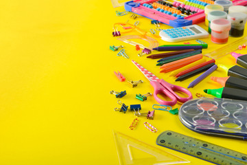 Set school supplies on yellow background. Top view.