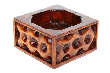 Old wooden ashtray with carved pattern isolated on white