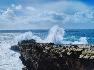 A wave crashes in the rocks
