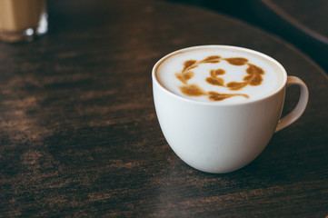 The cup of latte or cappuccino coffee with milk