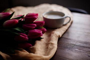 Cup of cappuccino and tulips.