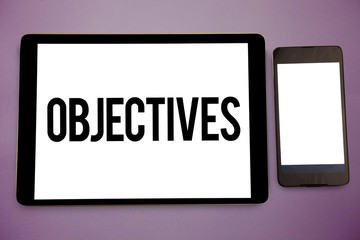 Writing note showing Objectives. Business photo showcasing Goals planned to be achieved Desired targets Company missions Wide framed white smart screen tablet text messages communicate idea.