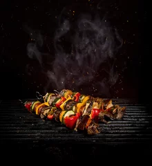 Plexiglas foto achterwand Chicken skewers on the grill with flames © Lukas Gojda