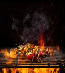 Foto op Aluminium Chicken skewers on the grill with flames © Lukas Gojda