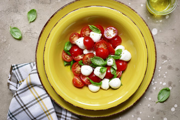 Traditional italian salad caprese with tomato, mozzarella cheese and basil.Top view.