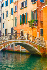 Obraz na płótnie Canvas Bridge and old houses by canal in Venice