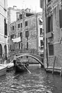 Venetian view with small canal with gondola