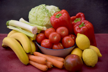 still life with tomatoes, peppers, lemons, carrots and lettuce