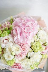 Floristry concept. Bouquet of beautiful flowers on gray table. Spring colors. the work of the florist at a flower shop.