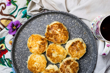 Freshly baked cottage cheese pancakes with raisins. Frying process. Top view