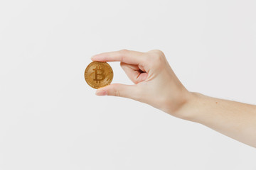 Close up female holds in hand bitcoin, metal coin of golden color isolated on white background. Finance design, virtual future currency bitcoin concept. Copy space for advertisement. Advertising area.