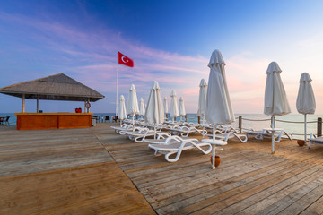 Obraz premium Beautiful scenery with wooden pier on Turkish Riviera at sunset, Side