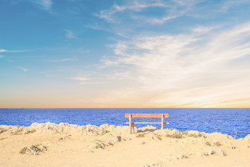 Beautiful view of a lonely bench over the sea