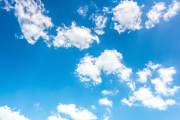 Blue sky with fluffy clouds as a background