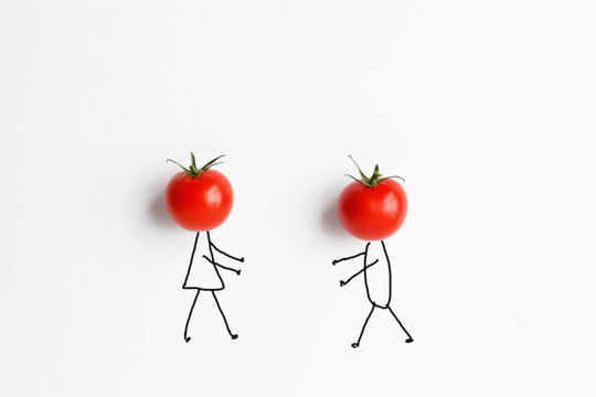 tomatoes with hand drawing shapes of couple in love