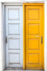 Rustic white and yellow doors of Greek island