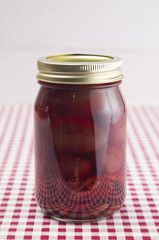 Beets on a Red Gingham Table Cloth in a Home Canning Jar