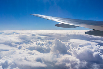Obraz premium Flying above the sky. Shape of the airplane wing on a blue sky.