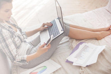 Young attractive woman working home at the laptop