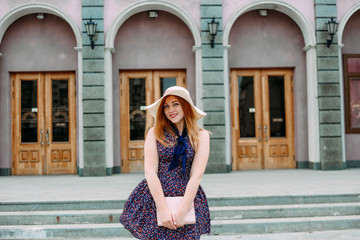 girl with smile light dress hat street