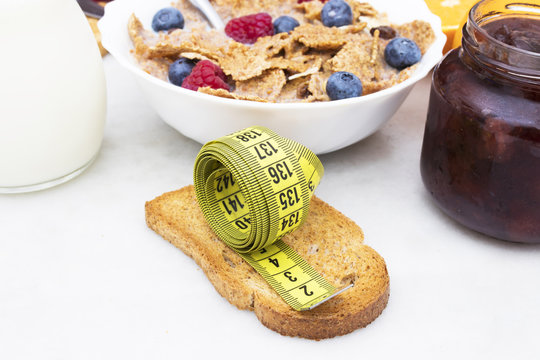 toasted bread with tape measure and healthy breakfast, concept of diet