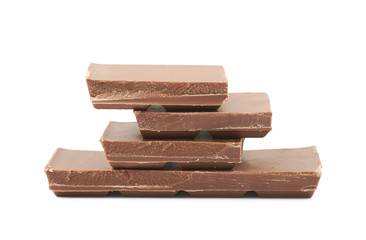 Pile of milk chocolate pieces isolated
