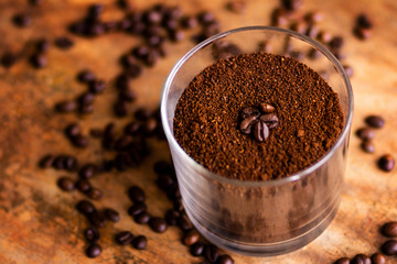 Ground coffee in a glass jar background