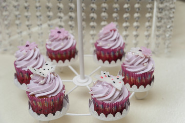 Pink cupcakes/Wedding candy bar featuring pink frosting on cupcakes arranged in a special support.