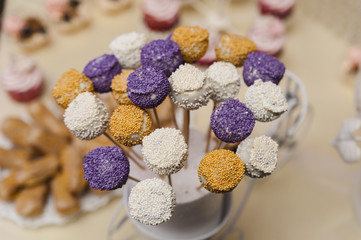 Candy bouquet/Colored fondant cake pops with candy sprinkles close-up in horizontal view from above.