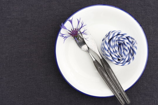 Table setting, white, blue, black. Symbols of Estonia.