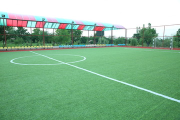 Fototapeta premium Mini Football Goal On An Artificial Grass . Inside of indoor football field . Mini football stadium center