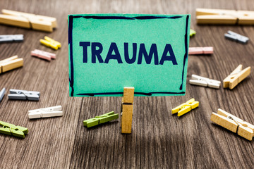 Text sign showing Trauma. Conceptual photo Disturbing physical and emotional injuries shock experience Random clips art work board creative nice paperclips wood grey shadow.