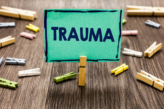 Text sign showing Trauma. Conceptual photo Disturbing physical and emotional injuries shock experience Random clips art work board creative nice paperclips wood grey shadow.