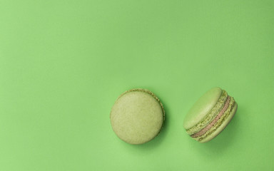 Green hazelnut Macarons on green background