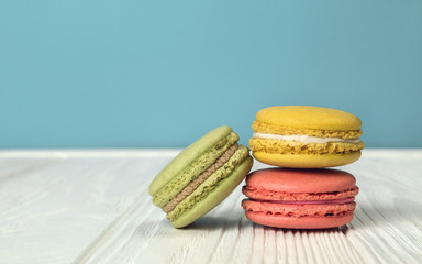 Lemon Strawberry and hazelnut flavor Macarons on wooden table and blue background