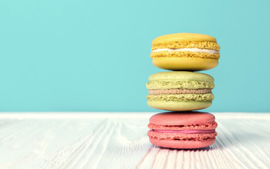 Lemon Strawberry and hazelnut flavor Macarons on wooden table and blue background