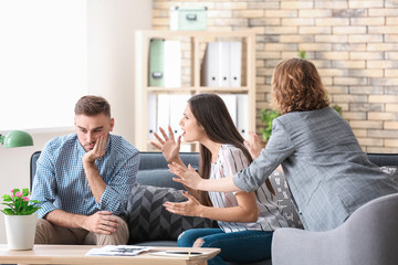 Psychologist working with married couple in office