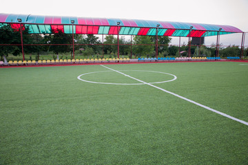 Mini Football Goal On An Artificial Grass . Inside of indoor football field . Mini football stadium center