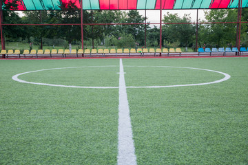Fototapeta premium Mini Football Goal On An Artificial Grass . Inside of indoor football field . Mini football stadium center . soccer field center and ball top view background